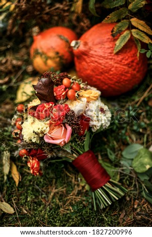 Juicy multicolored autumn wedding flowers collected in a large beautiful wedding decor in the woods