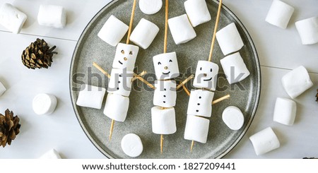 DIY white marshmallows sweet treat for kids funny marshmallow snowman in plate. Top view. Step by step. Christmas cones