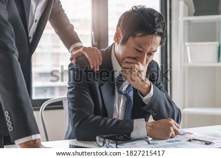 Colleague touch shoulder encouraging young businessman after work failure. Royalty-Free Stock Photo #1827215417