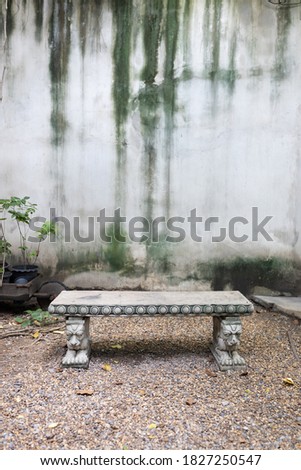 close up view of single ancient stone or concrete bench with sculptures of lions in park sideways
