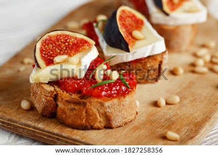 Bruschetta toast with cheese, fig, jam Royalty-Free Stock Photo #1827258356