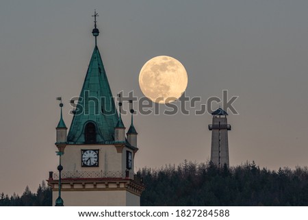 A beautiful shot of a full supermoon behind the Tisnov church