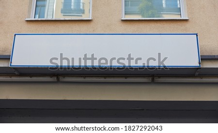 White company sign mock-up template on the house wall of a building