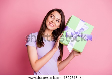 Portrait of beautiful tender girl hold present box look empty space wear casual outfit isolated on pink color background