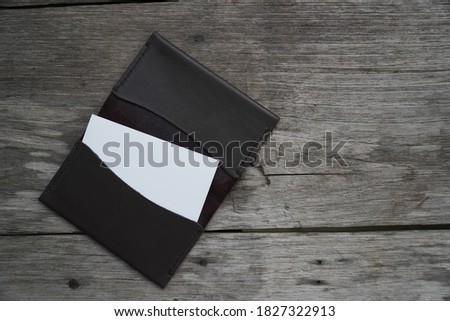 Business card mock up with card holder on old wooden table background