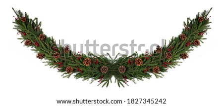 Winter and Christmas fir wreath composition with holly berries and pine cones isolated on white background with copy space