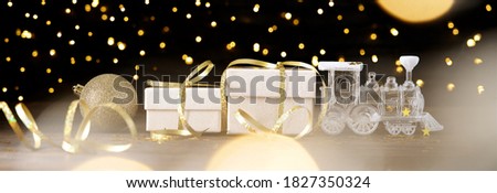 Gift boxes with Christmas train decoration. The fabulous atmosphere of the magic time on dark background