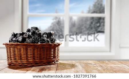 Table background of free space with christmast balls and winter window 