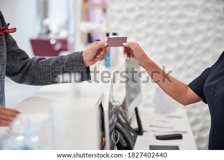 Cropped copy-space photo of a blank plastic card being passed from one person to another