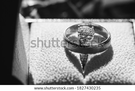 A diamond ring on a silver ring A wedding ring Black and white picture