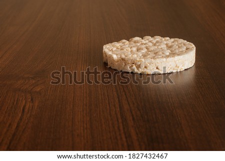 Rice cake (waffles) on a solid wooden table. A healthy, vegetarian snack. Simple food.  Royalty-Free Stock Photo #1827432467