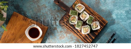 Unusual composition of rolls. Delicious food. A portion of rolls with an unusual filling. Asian delivery food. Sushi restaurant poster of Japanese food.