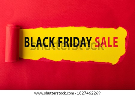 Red torn paper with  des scription BLACK FRIDAY DAY SALE on yellow background for background. Black Friday concept