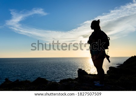 Silhouette of a nature traveler at sunset on the beach