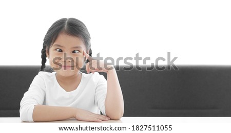 Asian child strabismus or kid girl squint lazy eye and amblyopia with finger point eye or brain head for think to lasik eye surgery technology with smile happy at nursery pre school on white space Royalty-Free Stock Photo #1827511055