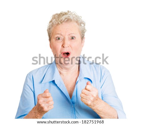 Closeup portrait of senior mature woman fists in air, anticipating something big about to happen, isolated white background. Positive emotion facial expression feelings, attitude, reaction, perception