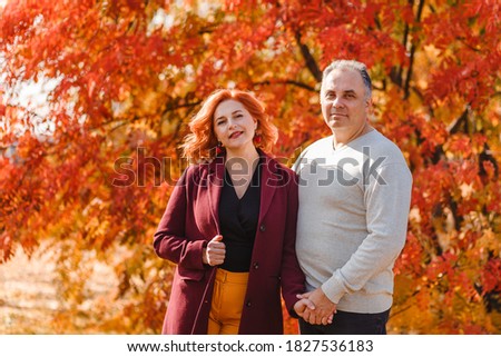 50-year-old man and woman with red hair fall