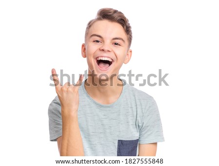 Handsome teen boy laughing looking very happy, isolated on white background.