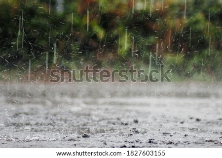 The rain was falling on the roadway due to a precipitation that was forming after the depression hit Thailand, causing heavy rains in some areas and flooding the road surface. Royalty-Free Stock Photo #1827603155