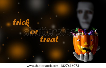 happy halloween card with a ghost giving candy