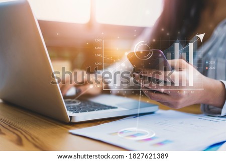 Close up businesswoman collecting data information converting into statistics, planning strategy gathering resources creating visual graphical graphs using computer laptop and smart mobile device Royalty-Free Stock Photo #1827621389