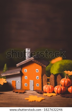 Miniature Thanksgiving Day little fairy autumn cottages, pumpkins, wooden background, postcard concept, toned