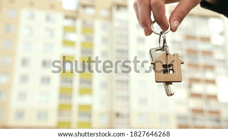 The girl holds the keys to a new apartment. The concept of buying a new apartment.