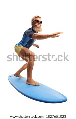 Bearded guy with sunglasses riding a surfboard isolated on white background