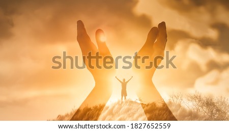 Mans worshiping hands raised up with open palms to the sunset sky. Religion and spirituality belief concept.  Royalty-Free Stock Photo #1827652559