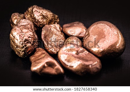 native copper nuggets isolated on black background, ore for industrial use in electrical wires and household utensils Royalty-Free Stock Photo #1827658340