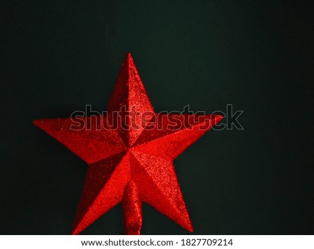 black christmas season background with a red star and photo captured with selective focus
