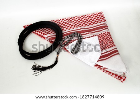 Arabic traditional clothing accessories called, Shemagh,Agal,White islamic cap and rosary isolated on white background,specially famous dressing of middle east countries Royalty-Free Stock Photo #1827714809