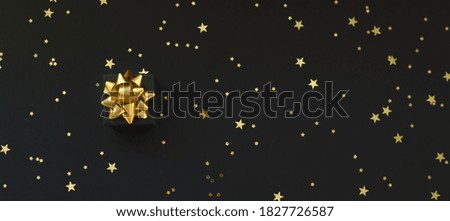 Black boxes of gifts on a black background with gold stars. Black Friday super sale. Horizontal banner, poster, website header