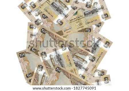 200 UAE dirhams bills flying down isolated on white. Many banknotes falling with white copyspace on left and right side