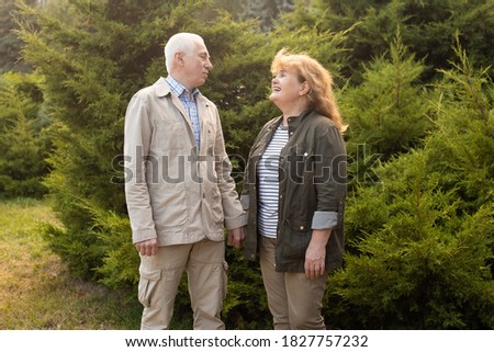 Mature couple in autumn park, senior couple relax in spring autumn time. Healthcare lifestyle elderly retirement love couple together