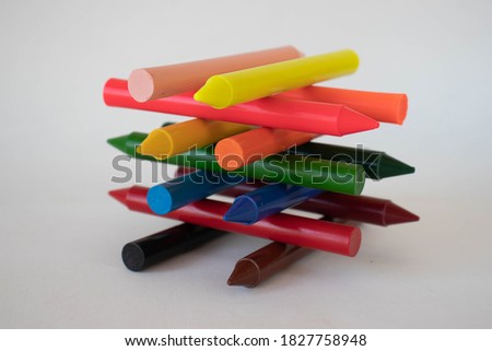 A pile of crayons on a white background