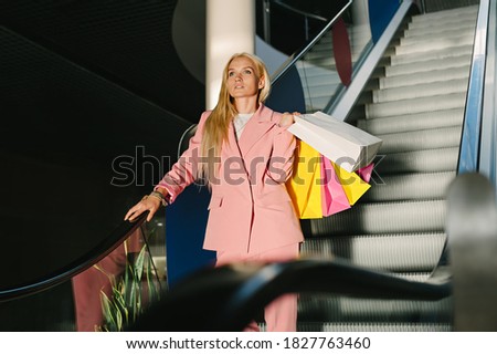 Happy woman with bags, enjoying your shopping. Concept on the theme of Black Friday