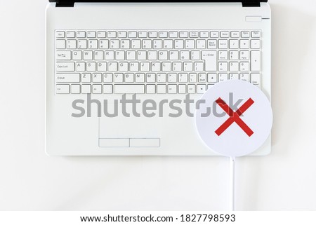Laptop and false sign taken with white background