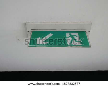 emergency fire exit sign on the ceiling in office.