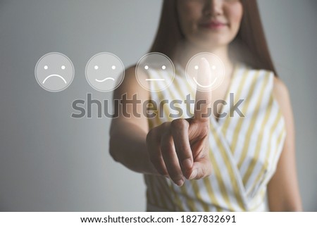 hand women pressing smile buttons on virtual touch screen