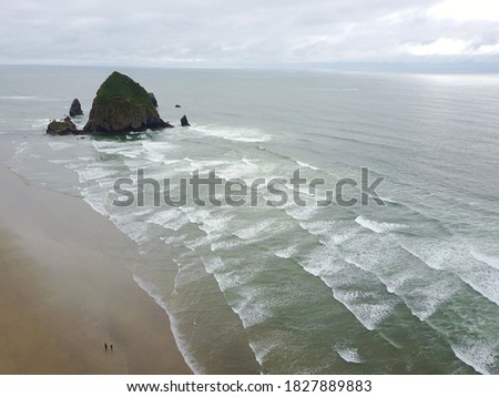 Drone photo of Oregon Cannon Beach in cloudy days 300 meter high with water waves