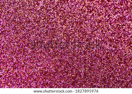 Scarlet red glitter texture. New Year or christmas background for greeting card. Valentines Day celebration. Shiny sparkle design for festive decoration: wedding, holiday or anniversary party.