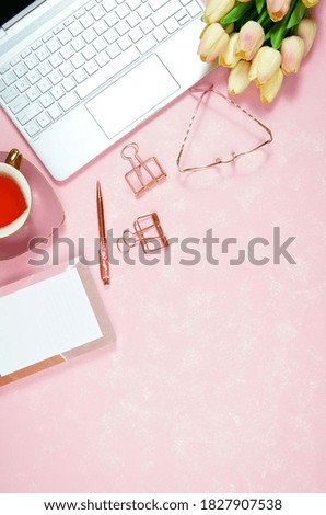 Feminine pink theme desktop workspace with laptop on stylish textured background. Top view blog hero header creative composition flat lay.