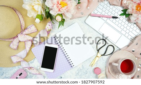 Spring theme, peonies and sunhat desktop workspace with laptop on stylish white marble textured background. Top view blog hero header creative composition flat lay.