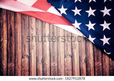 American flag on old wooden board.