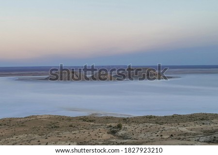 Sunrise over saline Kenderly on plateau Ustyurt. Kazakhstan desert, Aktau region. Morning ligth around.