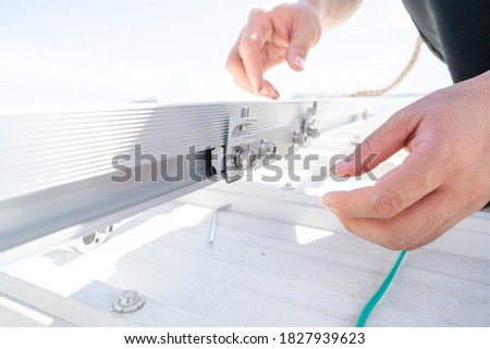 installing grounding in steel bar of solar rooftop power system by barehanded stock photo