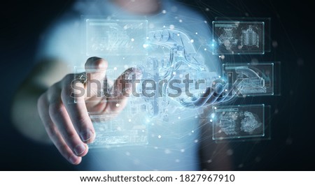Businessman on dark background holding and touching wireframe holographic digital projection of an engine 3D rendering