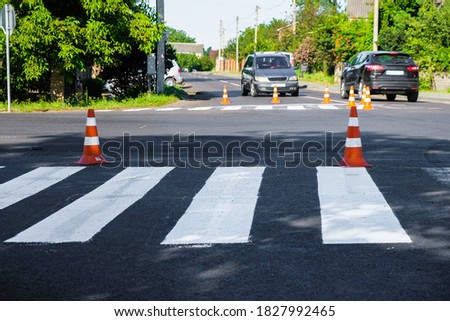 Marking of a pedestrian crossing at an intersection in Lutsk, Volyn, Ukraine. Road cones.