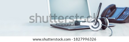 business and communications. Mockup laptop and voip phone in the office. Webinar or online conference. laptop on desk. IP telephony, Cold calling. Office work or learning. Copy space. Banner Royalty-Free Stock Photo #1827996326
